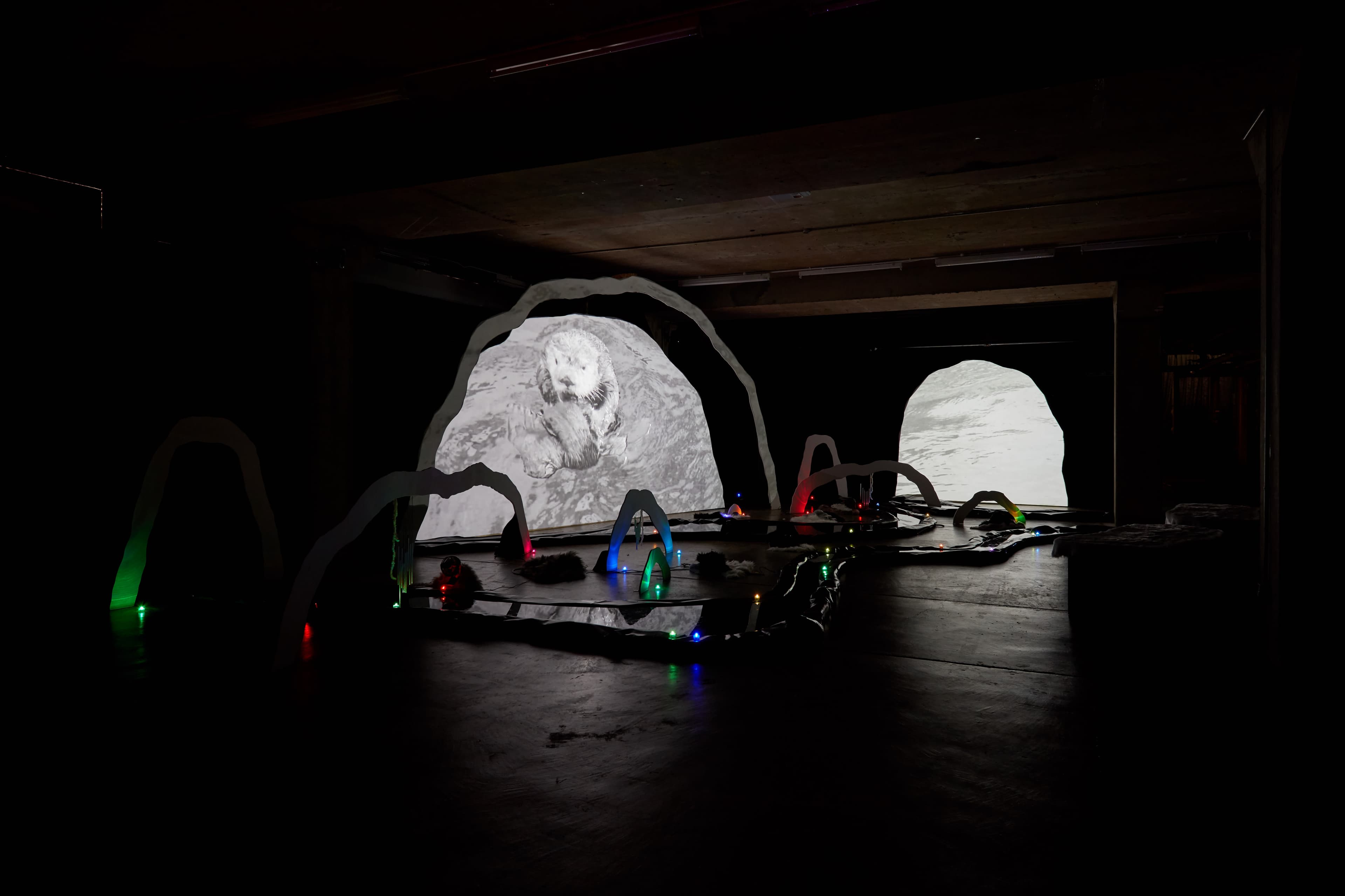 An installation by Hazel Brill of a number of amorphous forms with abstracted imagery projected onto them 