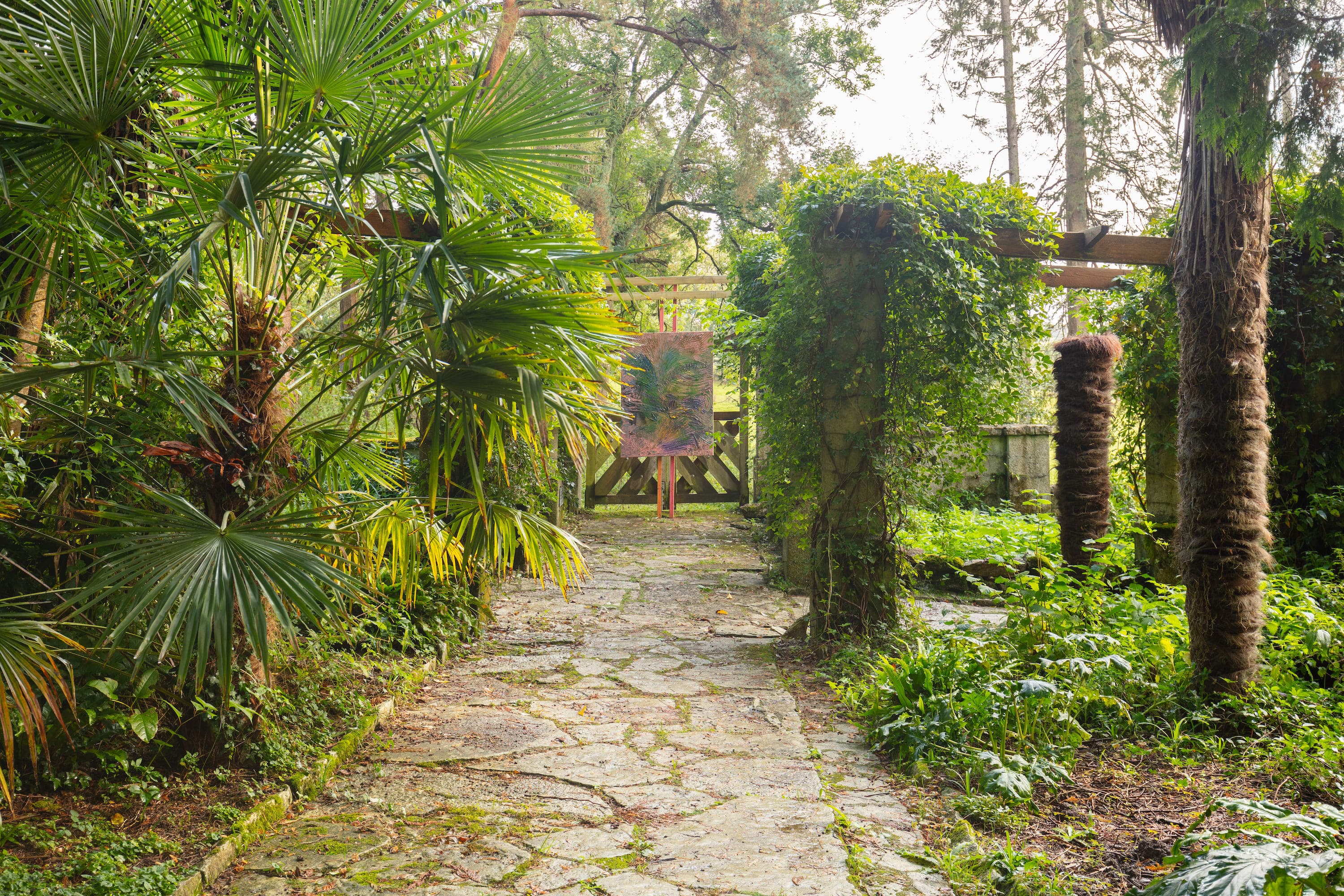 Artworks by James Cabaniuk installed outside in a lush green garden