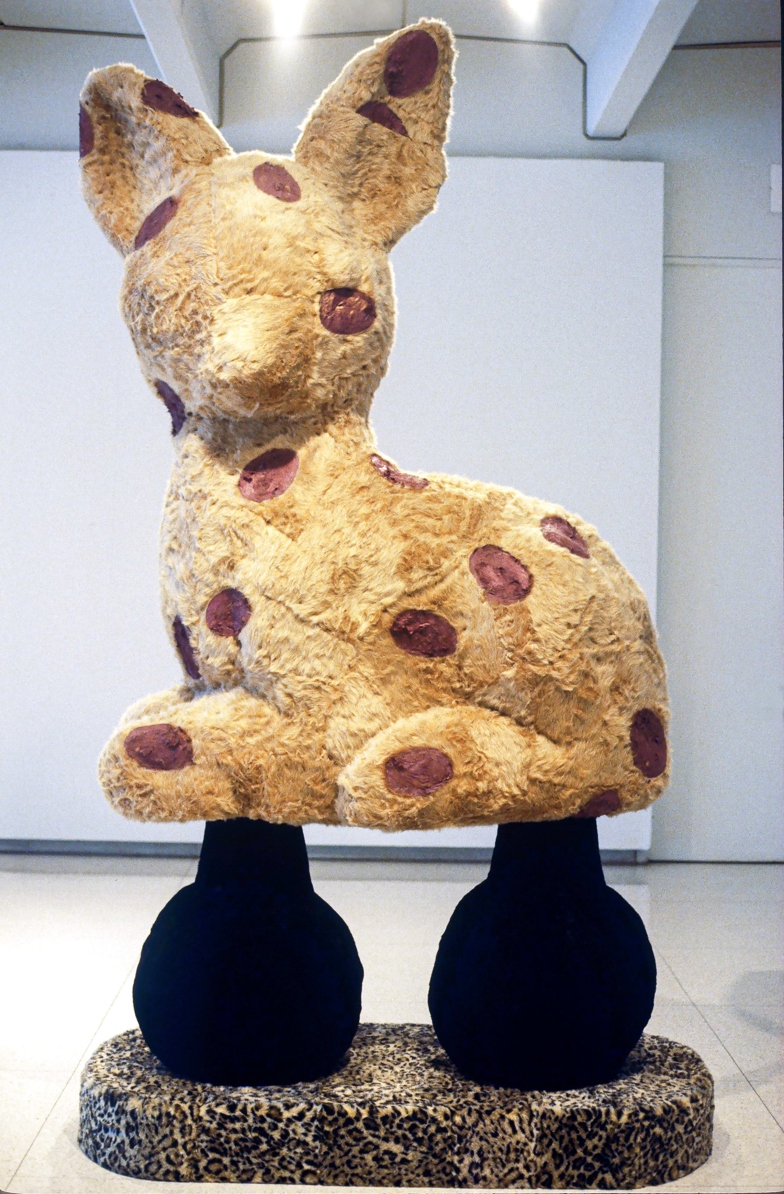 A giant Eric Bainbridge sculpture consisting of an oversized bambi with a hole and a handle covered in fake fur and paint