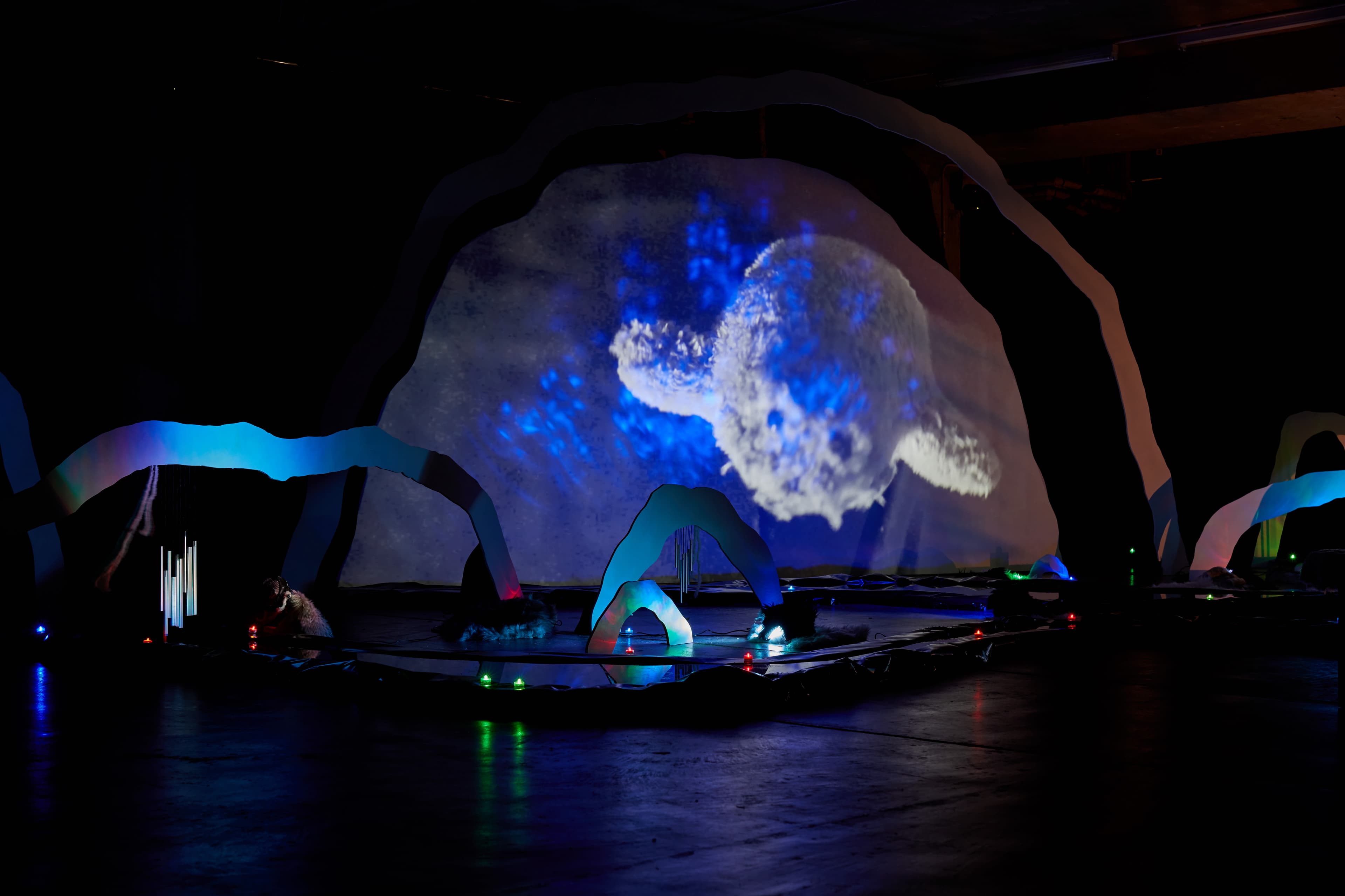 An installation by Hazel Brill of a number of amorphous forms with abstracted imagery projected onto them 