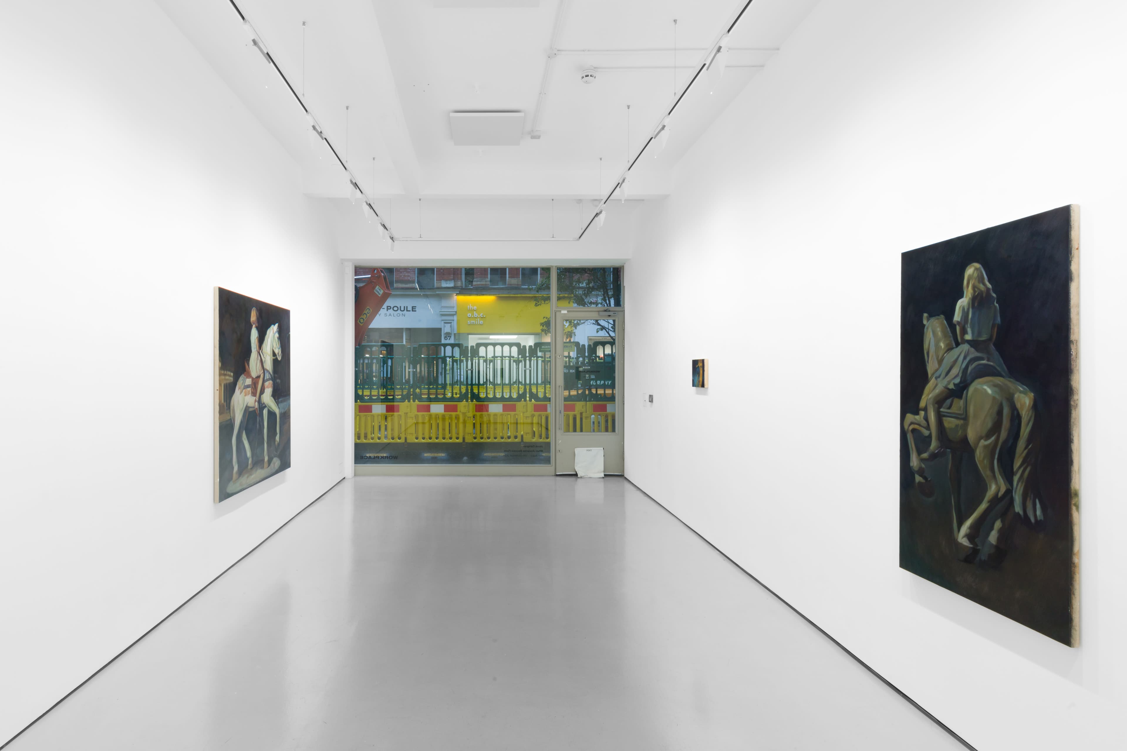 An installation view of Pei Wang's solo exhibition including several dark figurative paintings