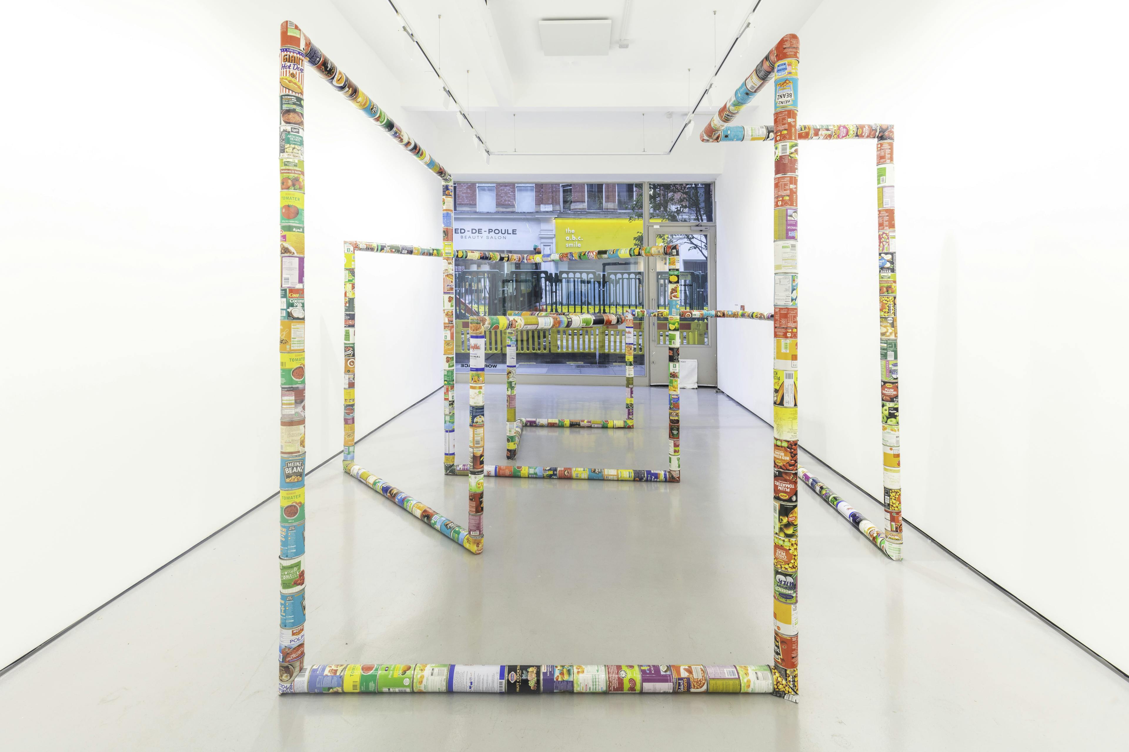 A sculpture by Jacob Dahlgren of various types of food cans connected end to end to create an endless loop