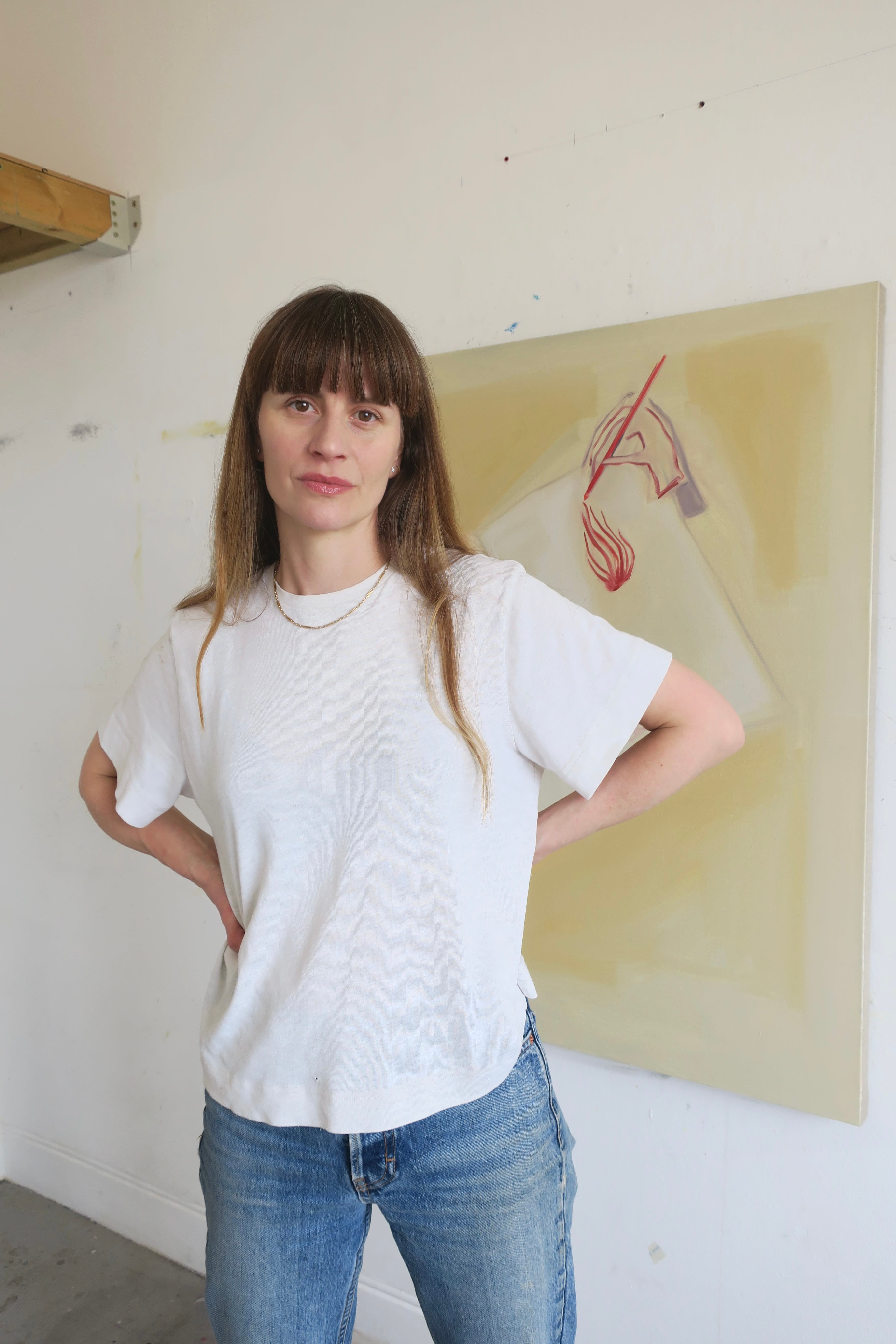 A portrait of artist Eve Ackroyd stood in her studio