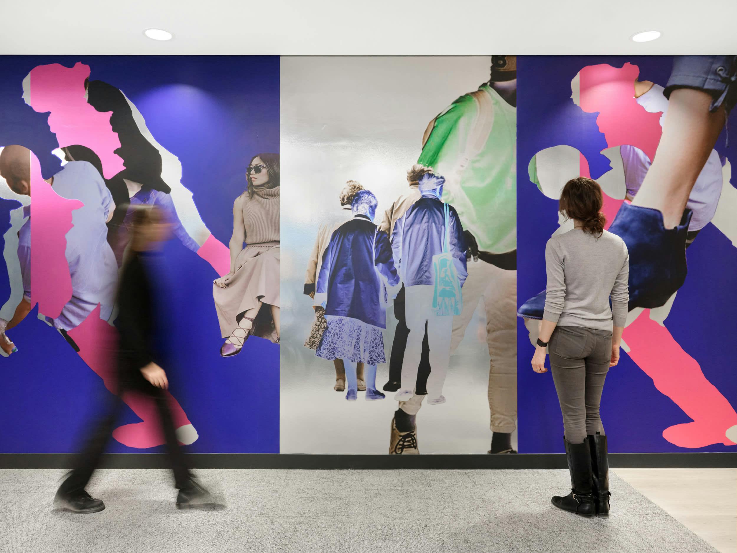 An installation by Simeon Barclay in an office composed of bright collaged people standing and walking