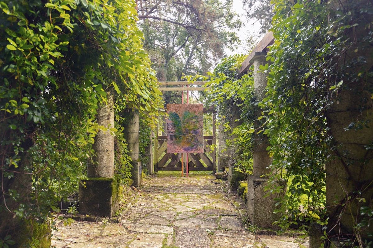 Artworks by James Cabaniuk installed outside in a lush green garden