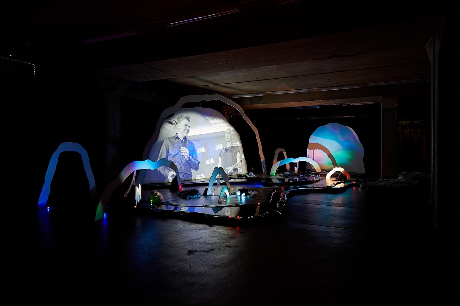 An installation by Hazel Brill of a number of amorphous forms with abstracted imagery projected onto them 