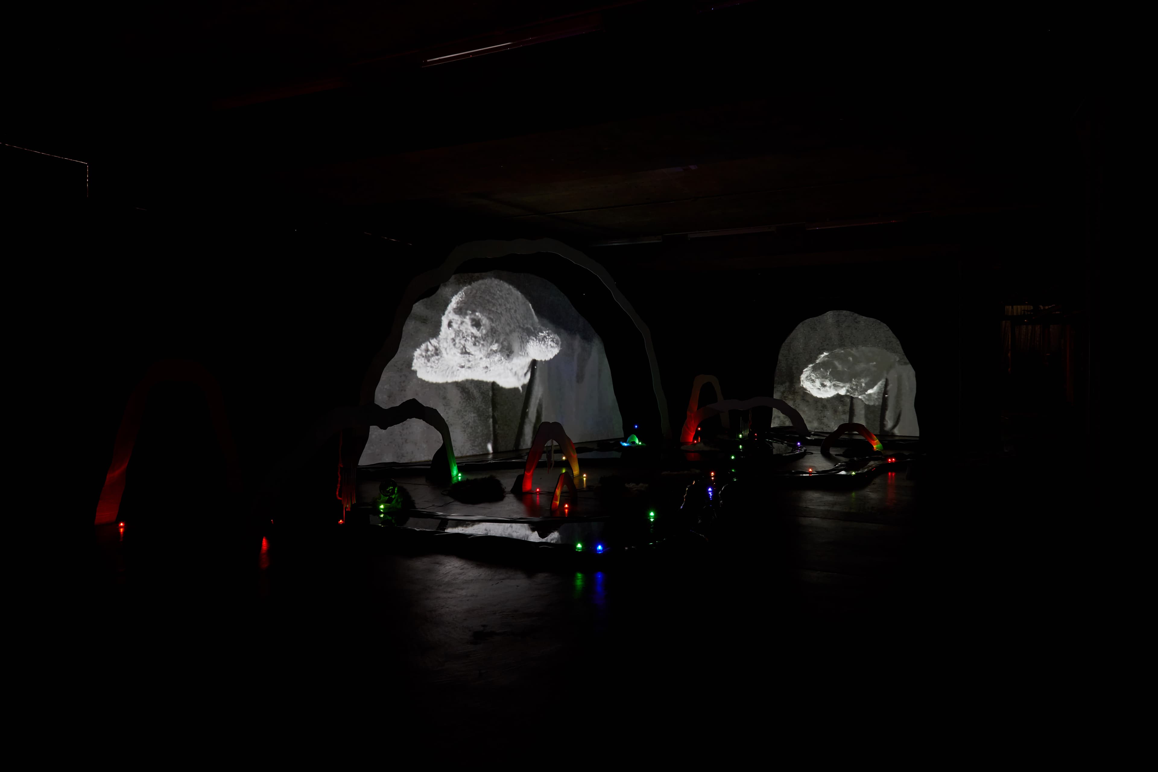 An installation by Hazel Brill of a number of amorphous forms with abstracted imagery projected onto them 