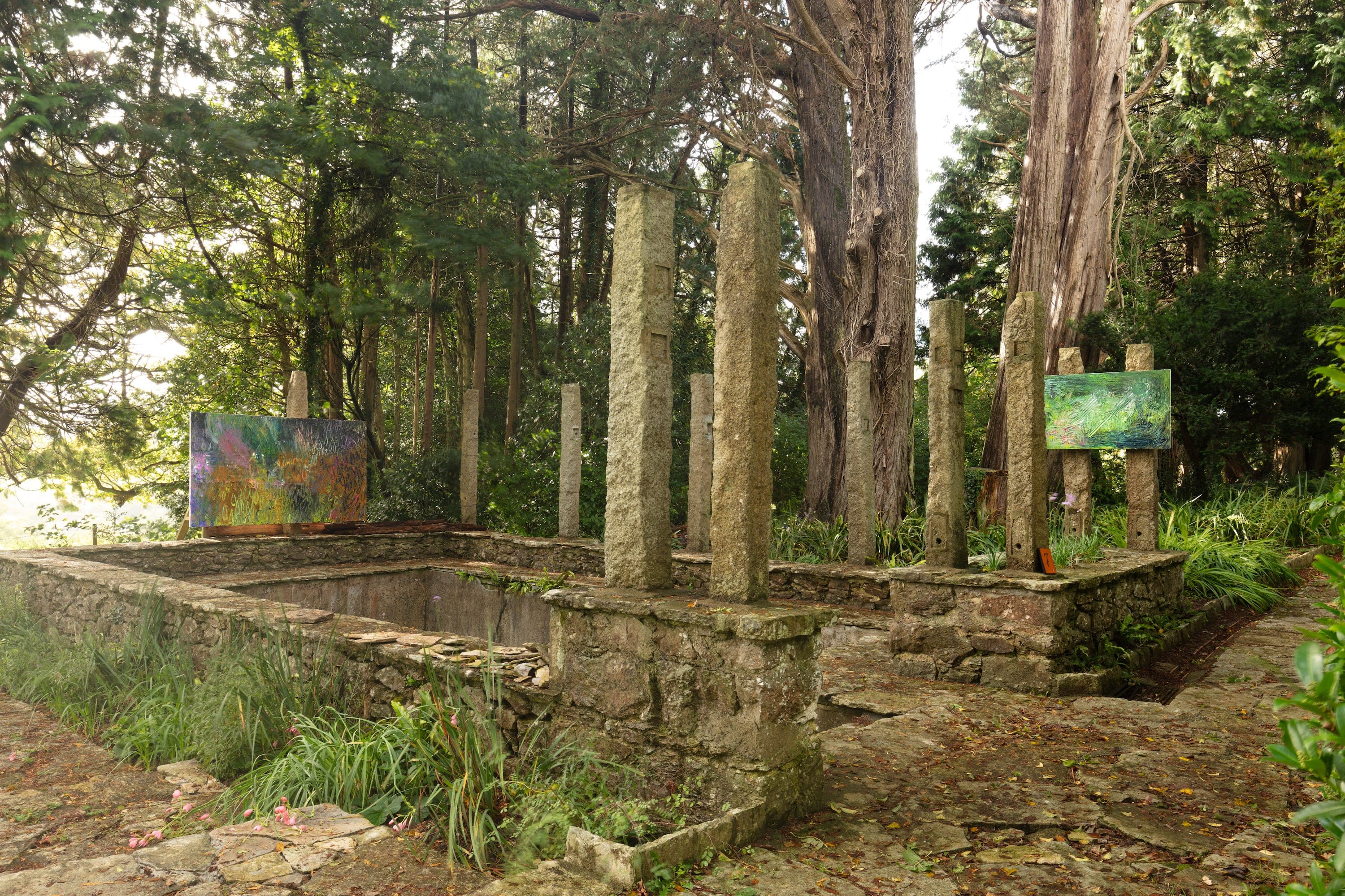 Artworks by James Cabaniuk installed outside in a lush green garden