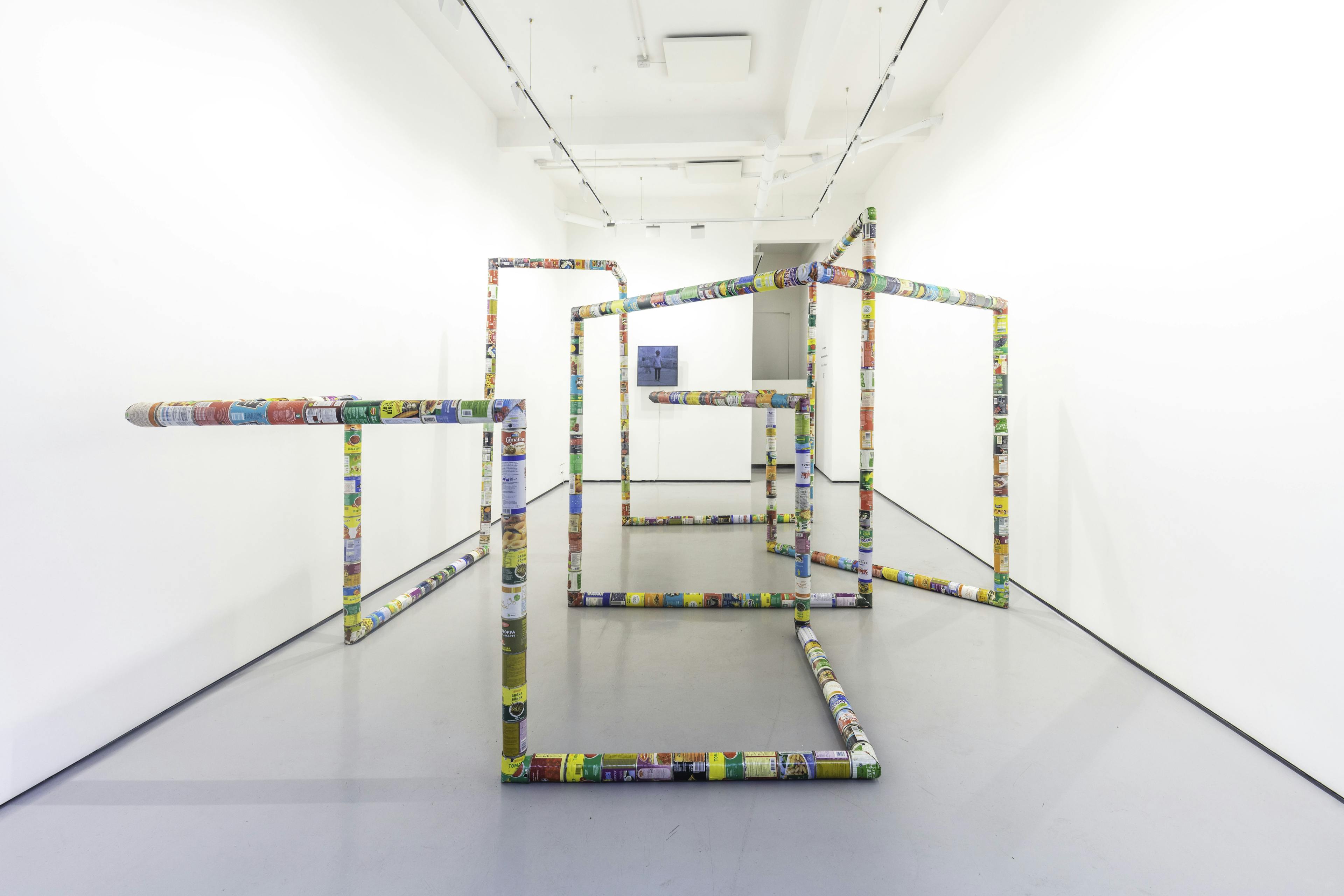 A sculpture by Jacob Dahlgren of various types of food cans connected end to end to create an endless loop