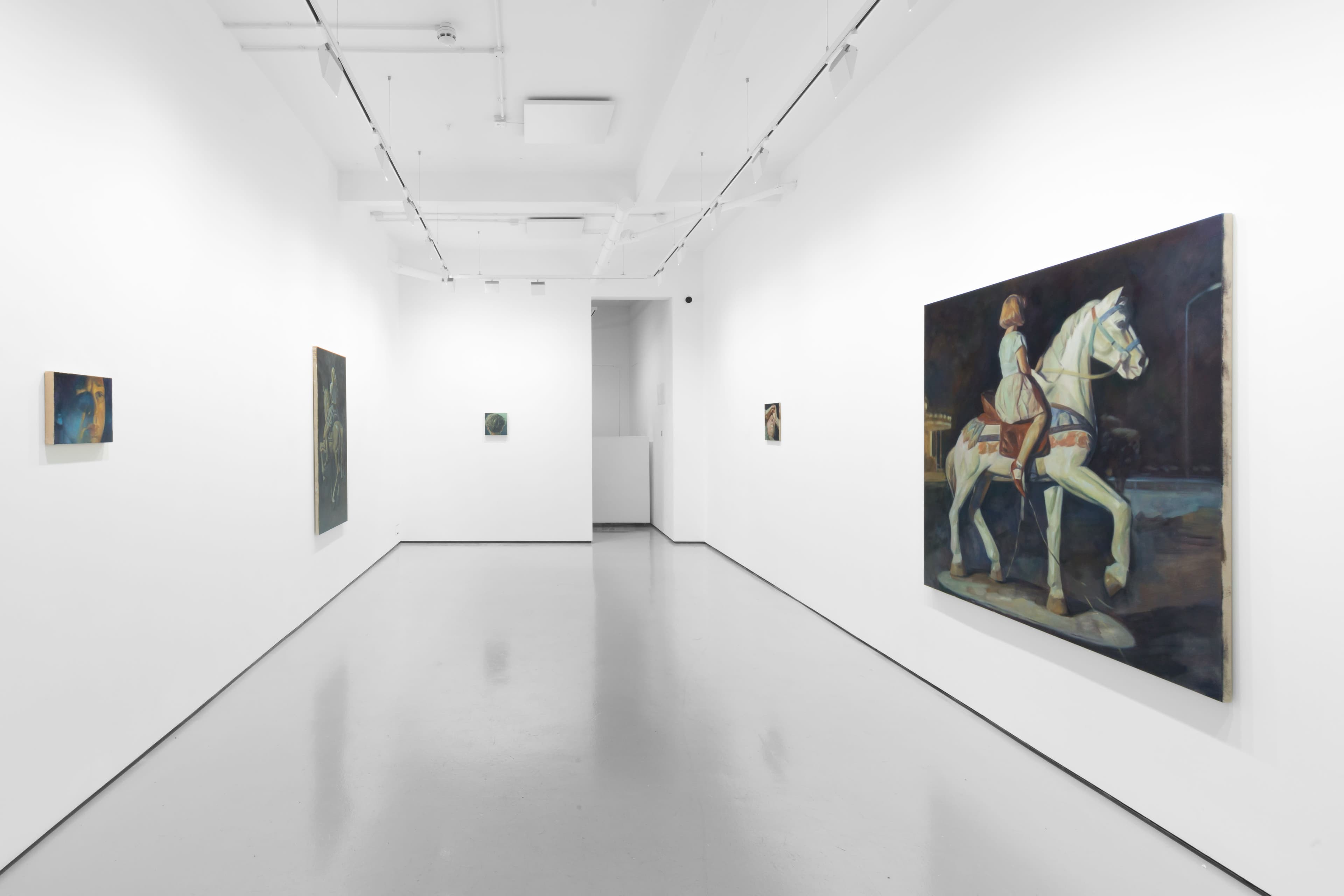 An installation view of Pei Wang's solo exhibition including several dark figurative paintings