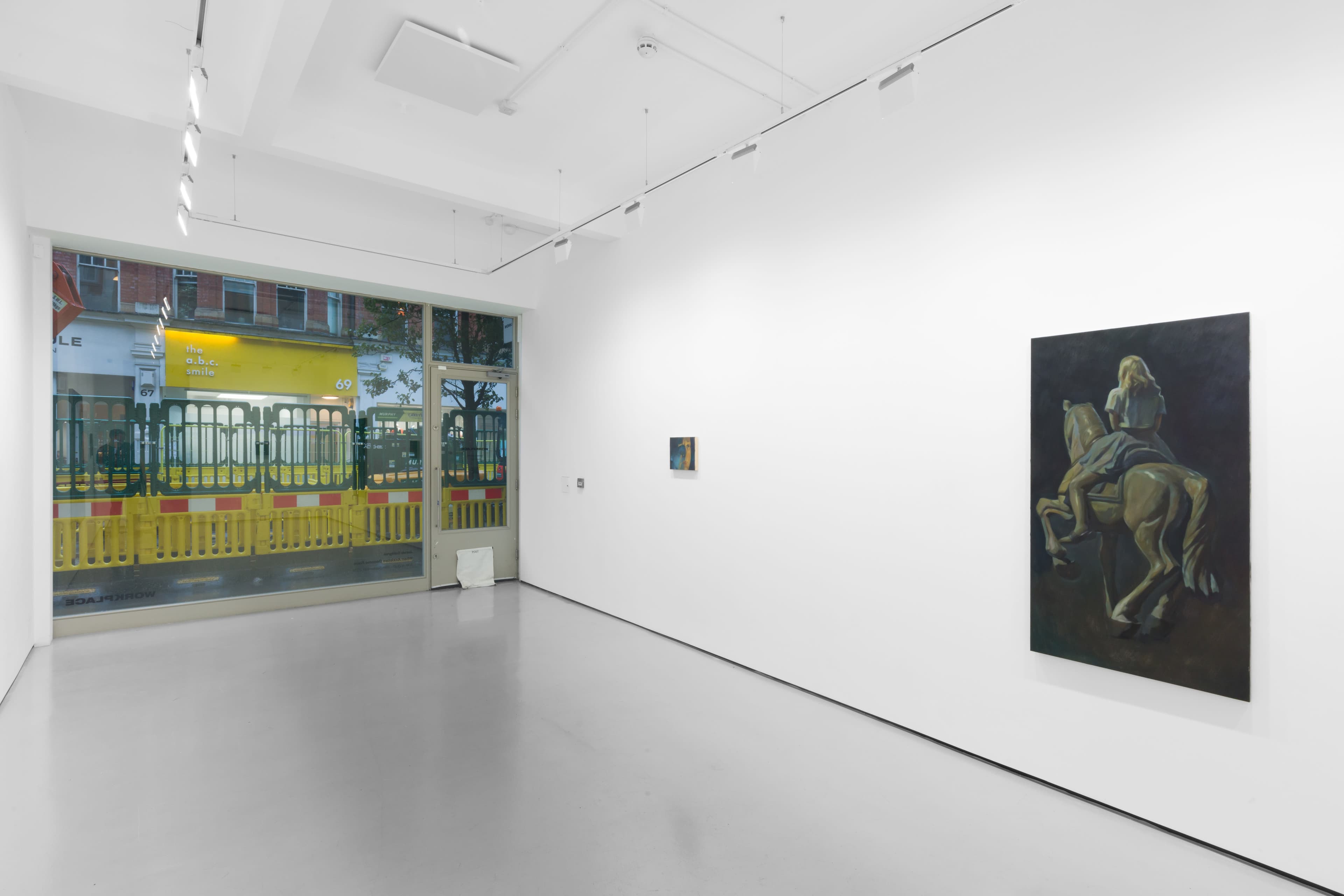 An installation view of Pei Wang's solo exhibition including several dark figurative paintings