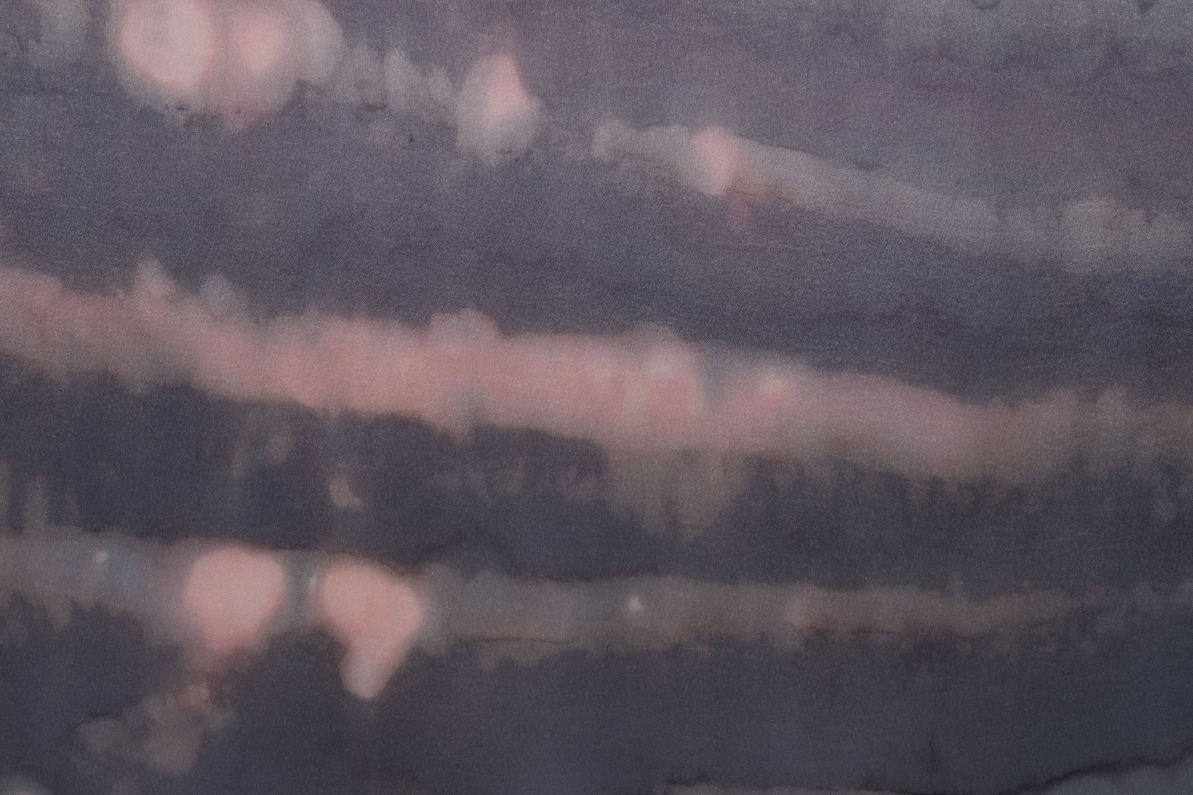 A large painting by Max Boyla. Dark purple background with a light bleached white and pink spot on the top of the canvas and lighter peach coloured markings on the bottom.