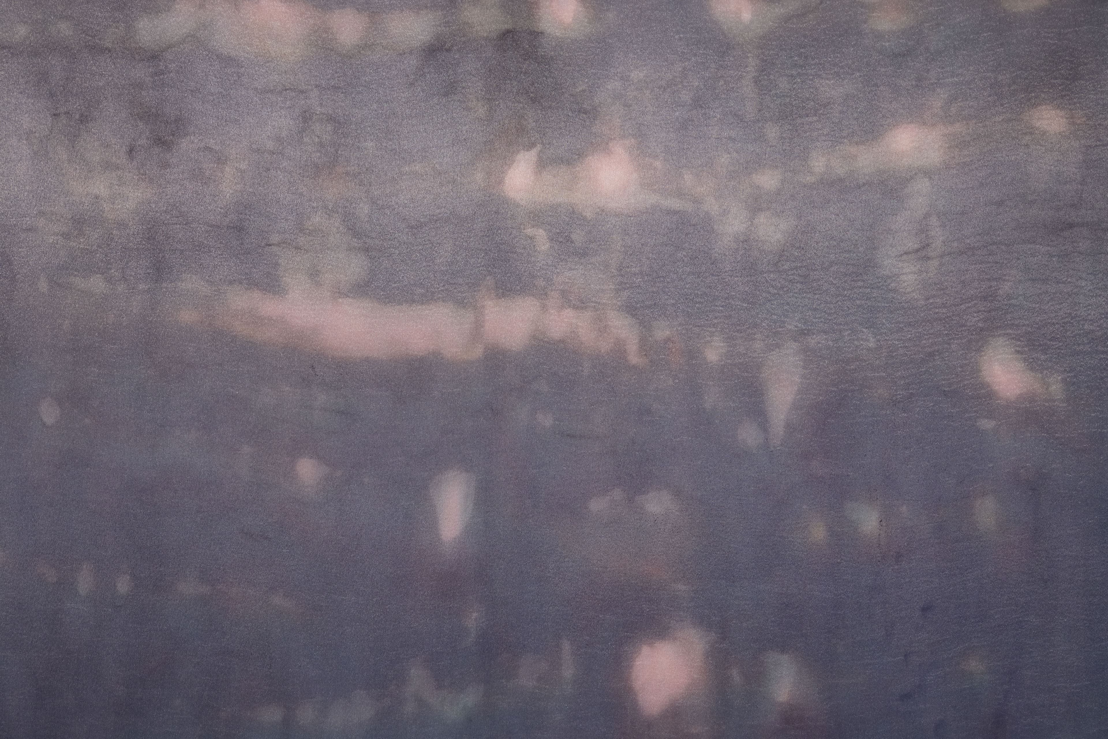 A large painting by Max Boyla. Dark purple background with a light bleached white and pink spot on the bottom of the canvas and lighter peach coloured markings on the top.