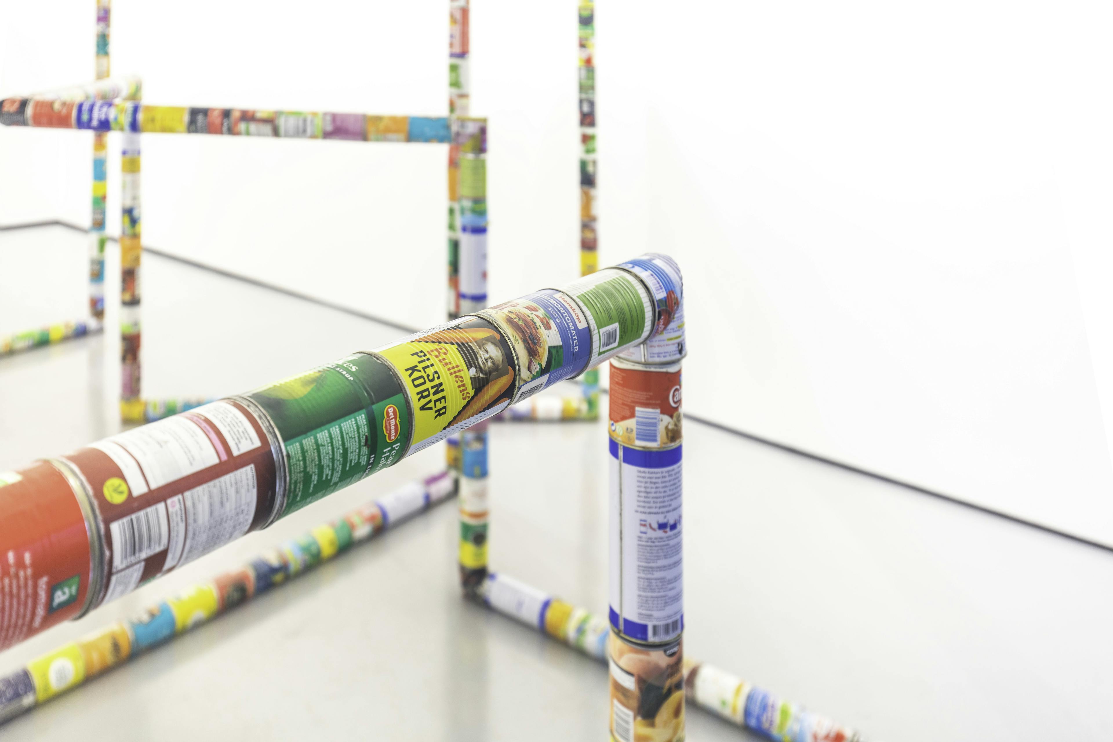 A sculpture by Jacob Dahlgren of various types of food cans connected end to end to create an endless loop