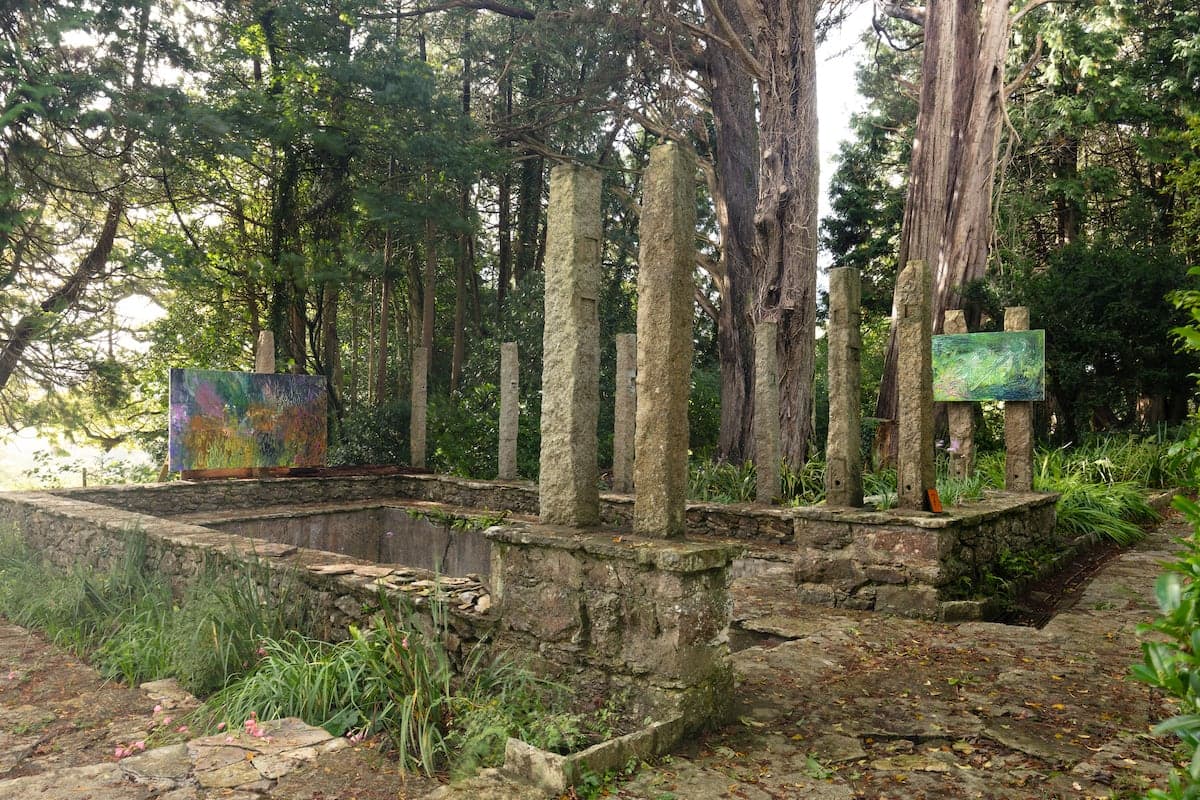 Artworks by James Cabaniuk installed outside in a lush green garden