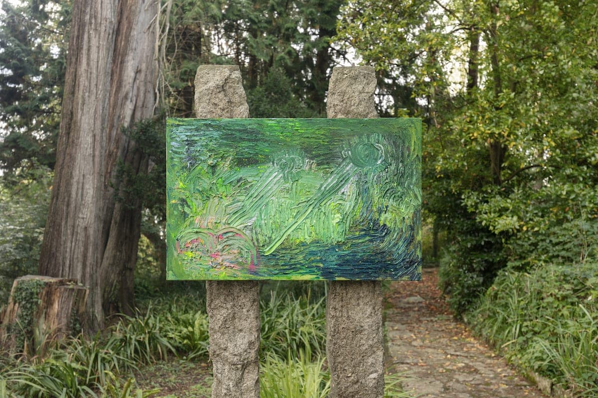 Artworks by James Cabaniuk installed outside in a lush green garden