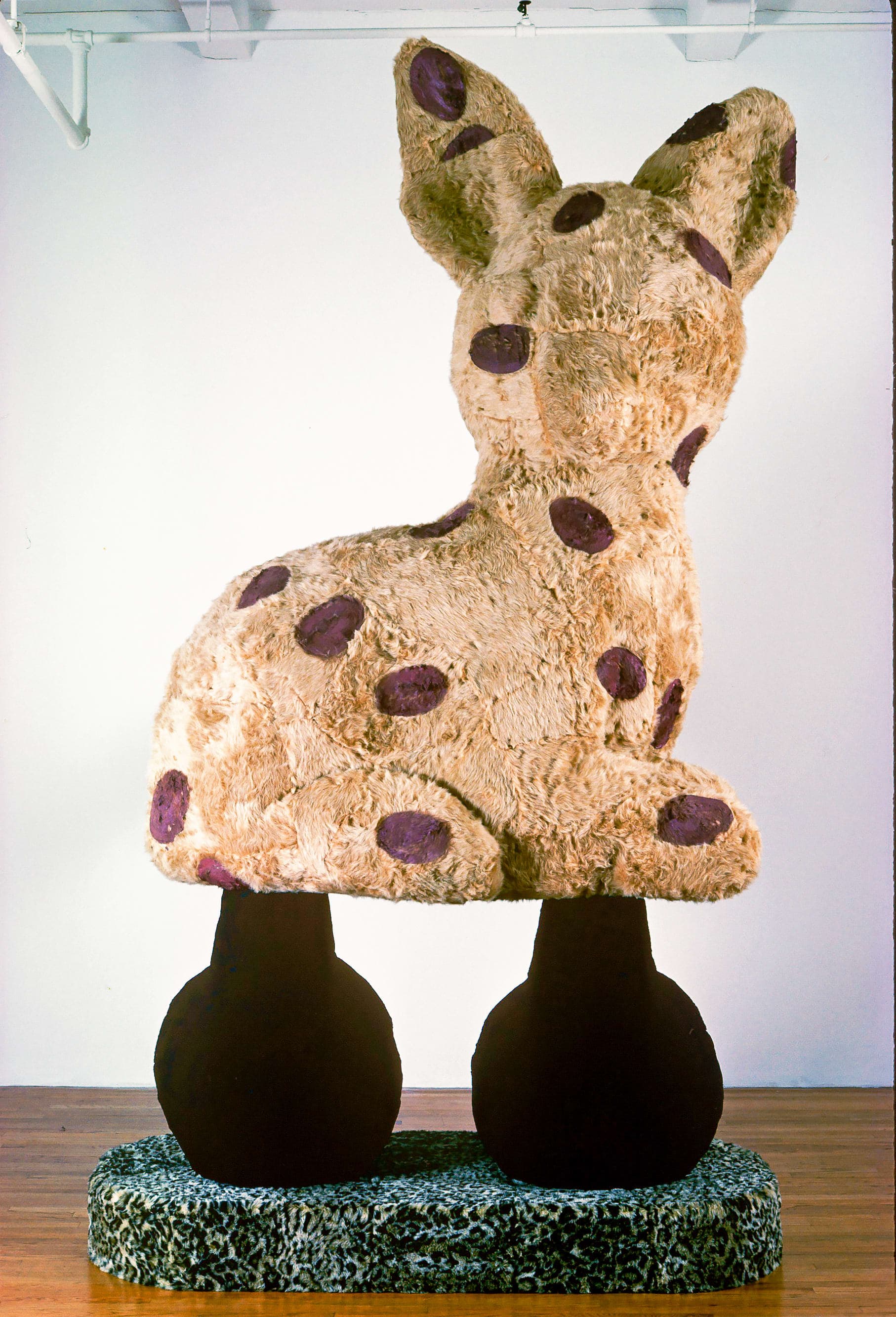 A giant Eric Bainbridge sculpture consisting of an oversized bambi with a hole and a handle covered in fake fur and paint