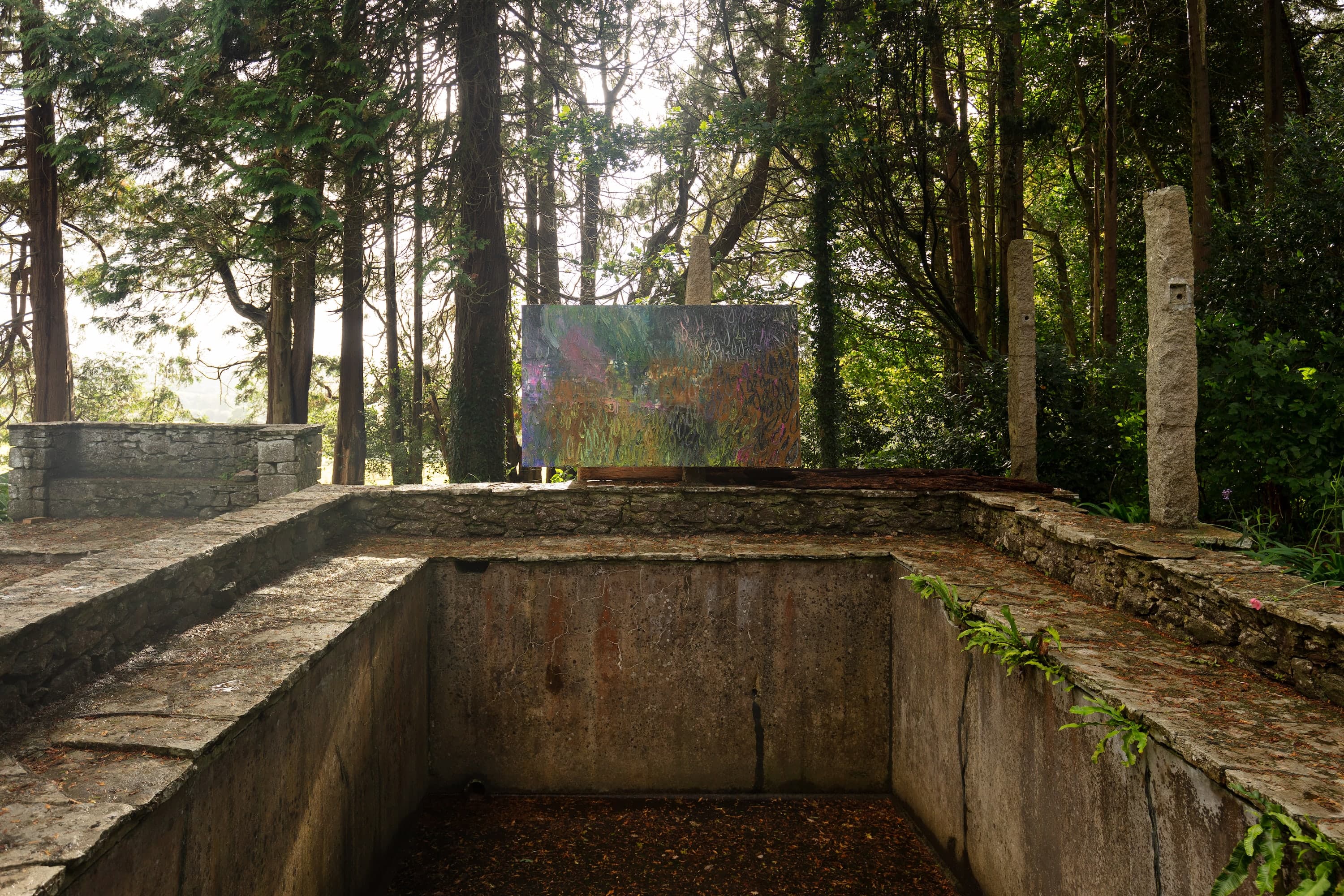 Artworks by James Cabaniuk installed outside in a lush green garden