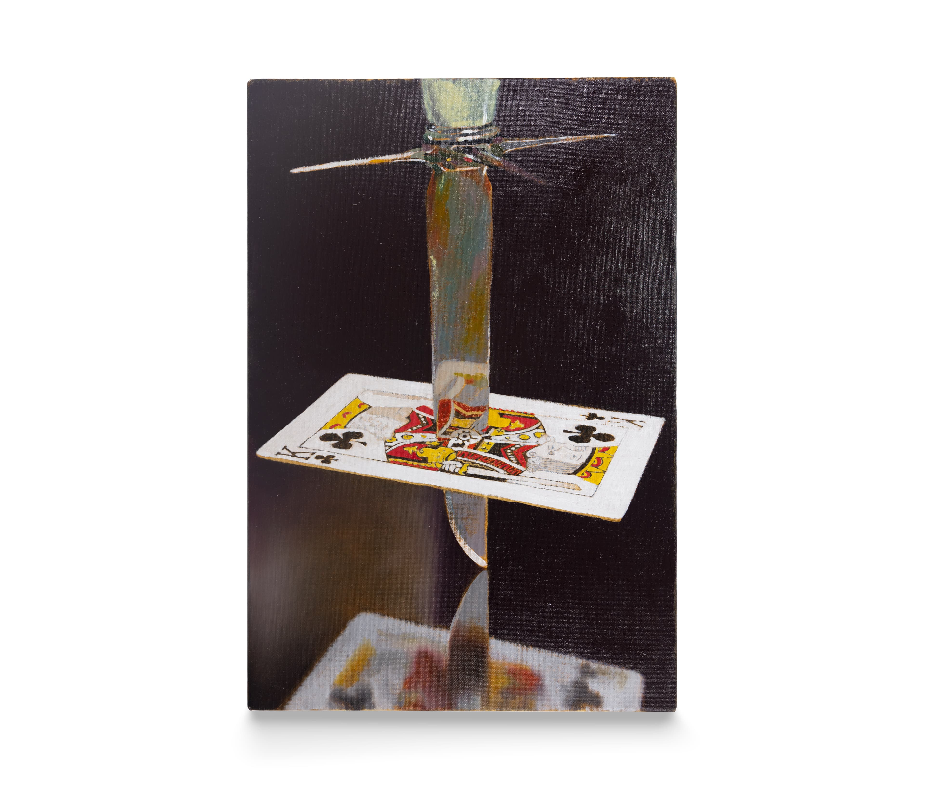 a dagger pierces a king of clubs card above a mirrored surface