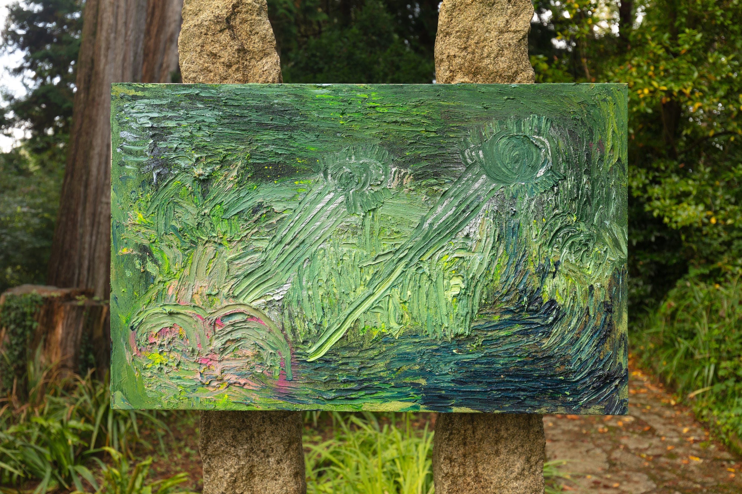 Artworks by James Cabaniuk installed outside in a lush green garden