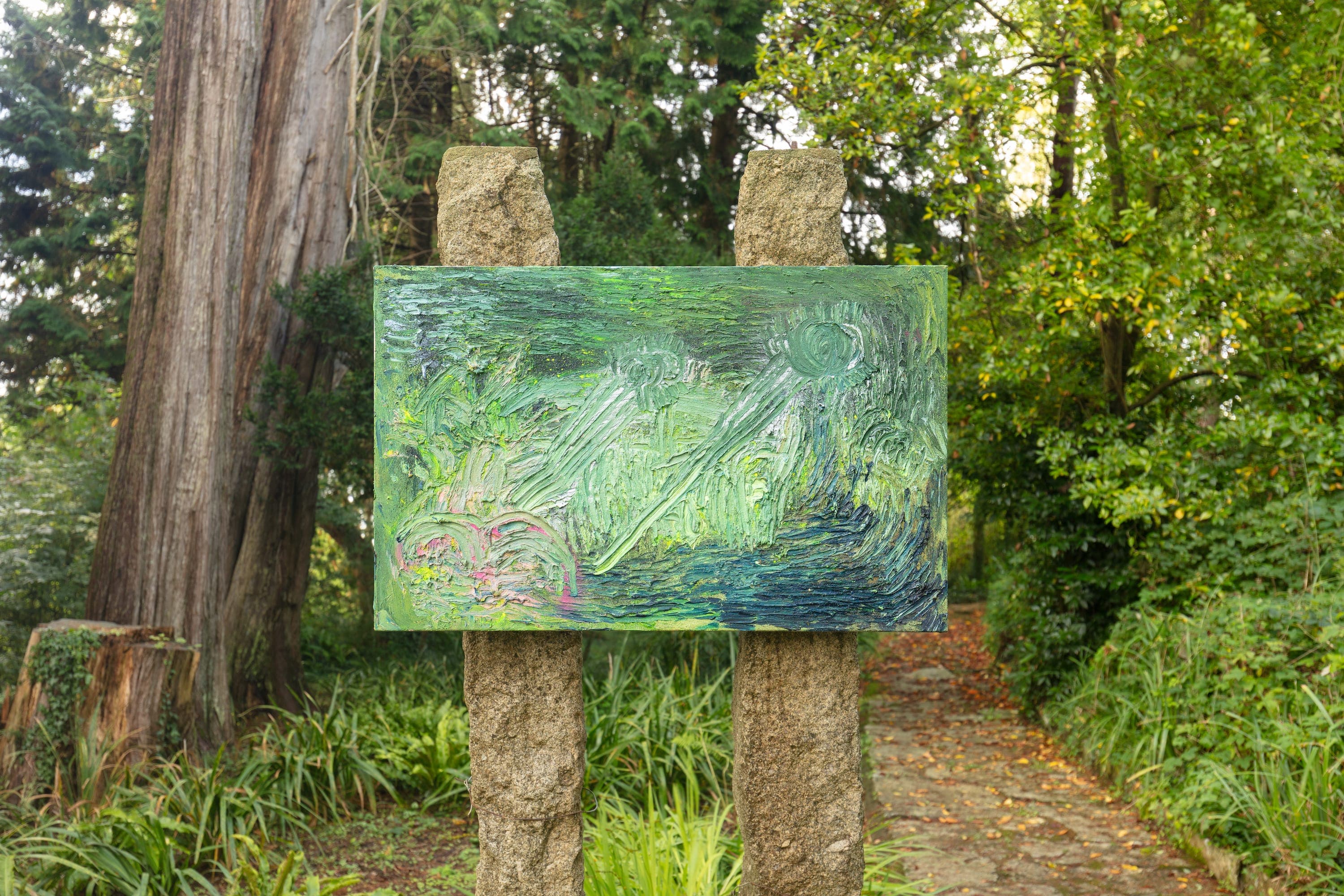 Artworks by James Cabaniuk installed outside in a lush green garden