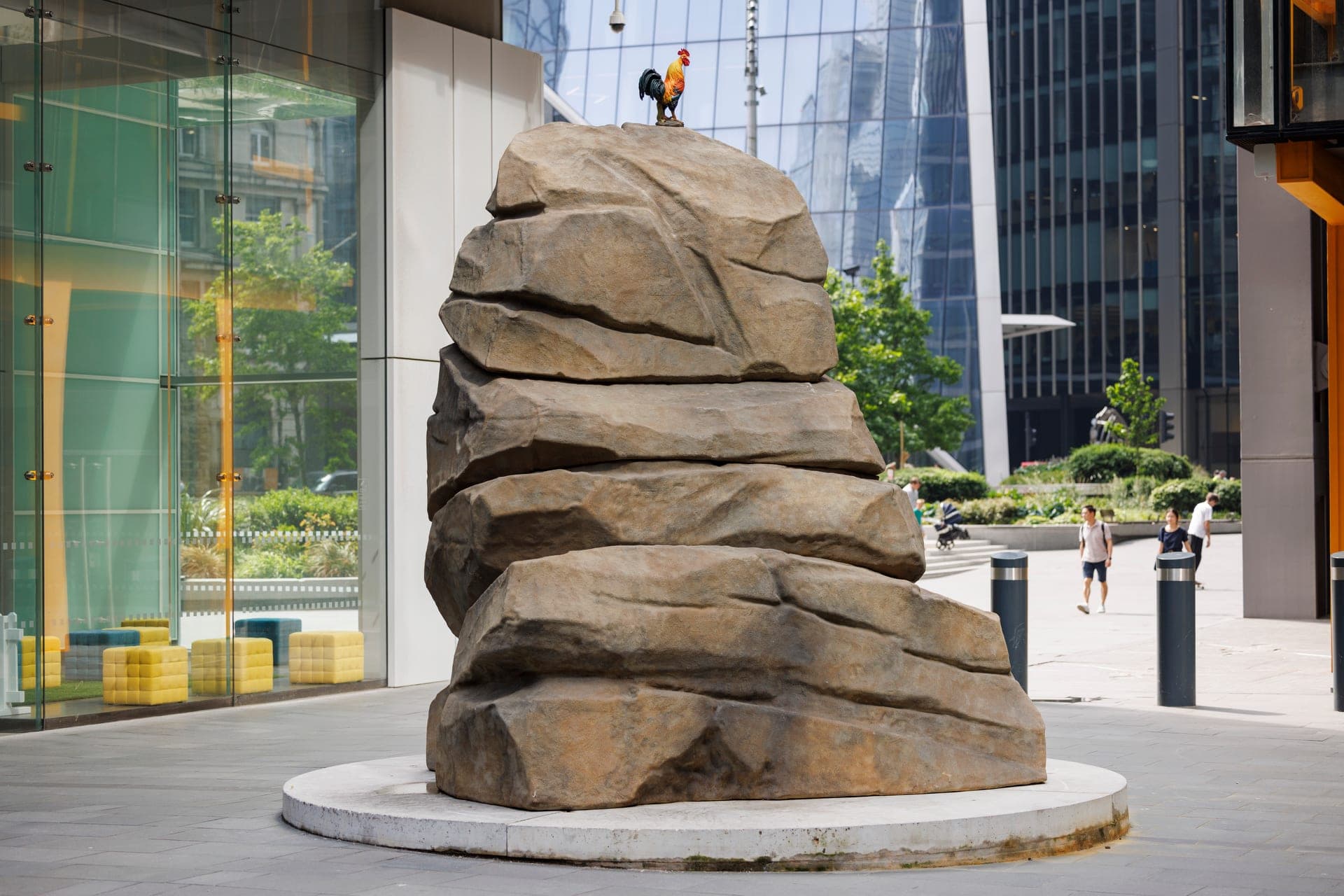 A large sculpture by Simeon Barclay of a boulder with a cockerel stood on top