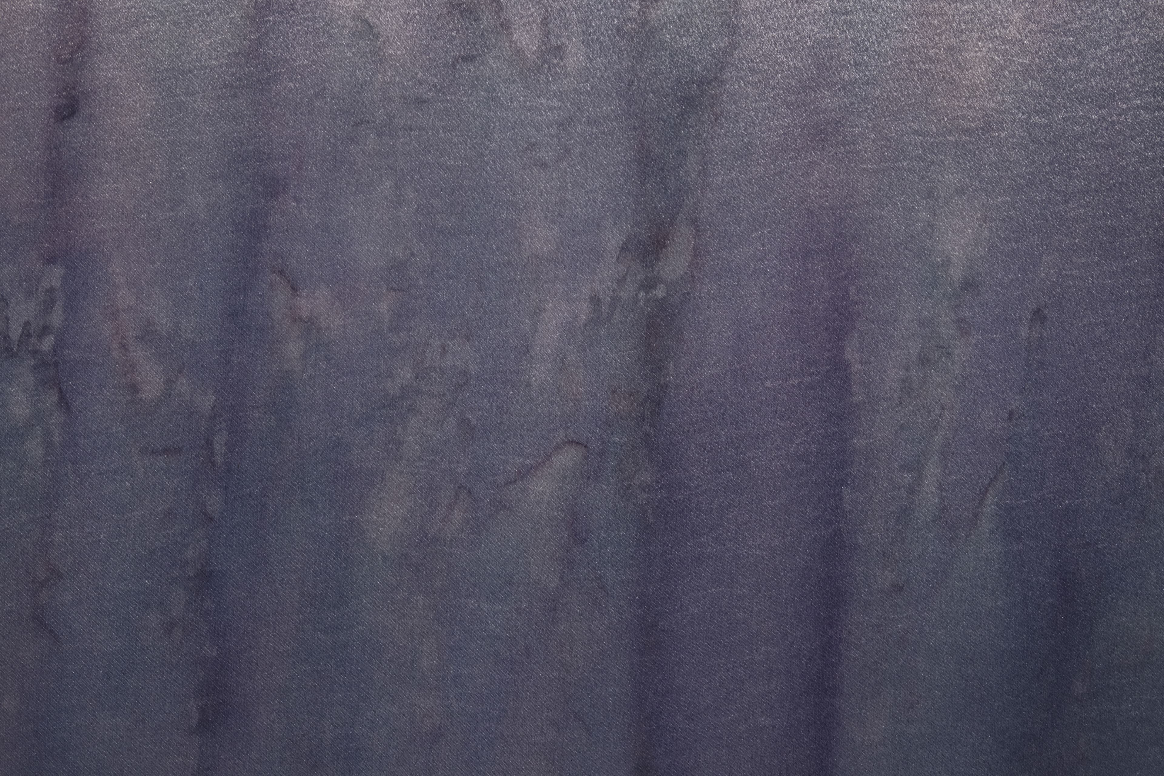 A large painting by Max Boyla. Dark purple background with a light bleached white and pink spot on the bottom of the canvas and lighter peach coloured markings on the top.