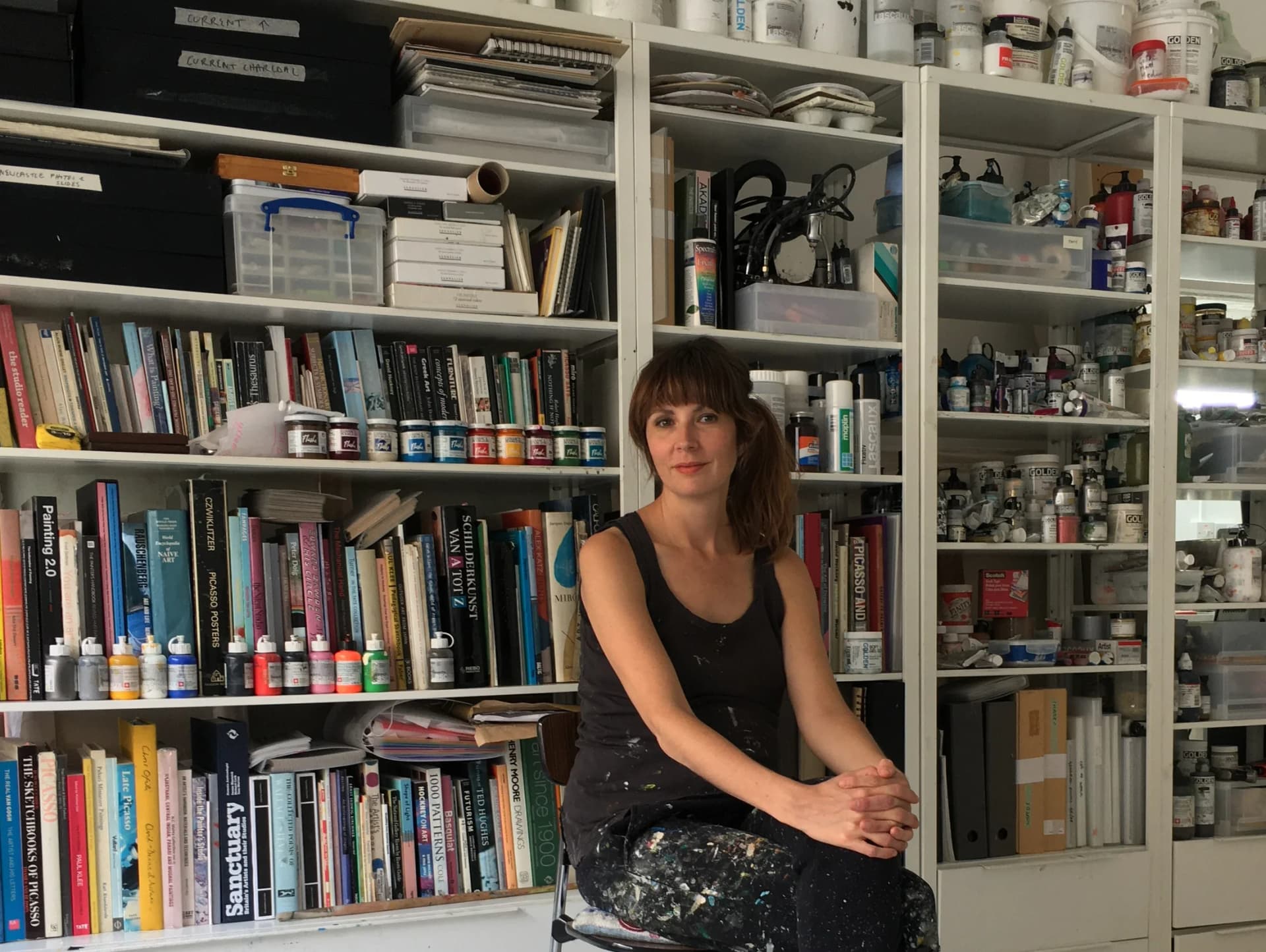 A portrait of Phoebe Unwin sat in front of a bookshelf