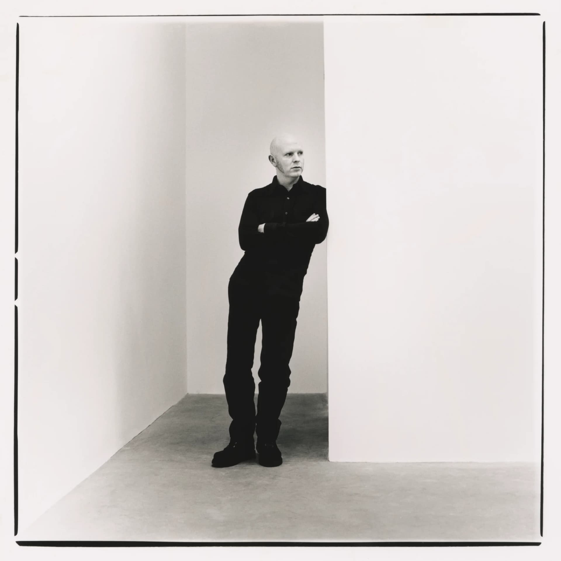 A portrait of William McKeown leaning against a wall