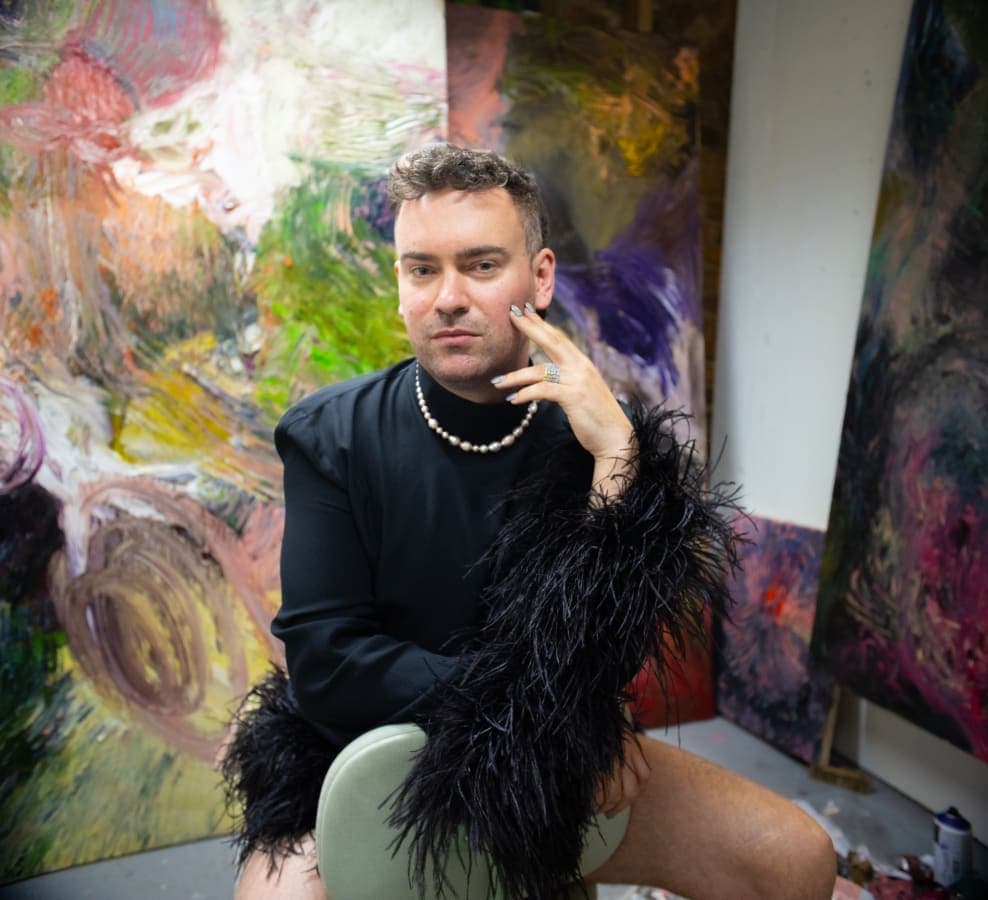 James Cabaniuk in front of their work